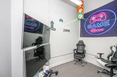 a room with two chairs and signs on the wall at The 333 Suites 302 - Stay for 6 in Cincinnati