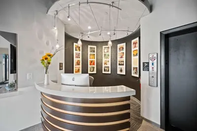a lobby with a bar with a vase of flowers at The 333 Suites 303 - Suite for 6 in Cincinnati