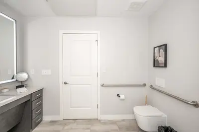 a white bathroom with a toilet and a sink at The 333 Suites 304 - Stay for 2 in Cincinnati