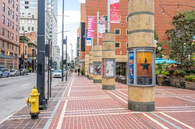 a yellow fire hydrant on a city street with buildings at The 333 Suites 304 - Stay for 2 in Cincinnati