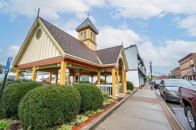a large building with a clock tower on a street at The Gathering House - Home for 6 in Harrison