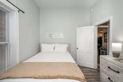 a white bedroom with a bed and a window at The Washington Cottage - 6ppl in Harrison