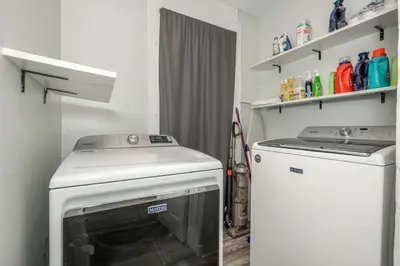 a laundry room with a dryer and a washer at The Washington Cottage - 6ppl in Harrison