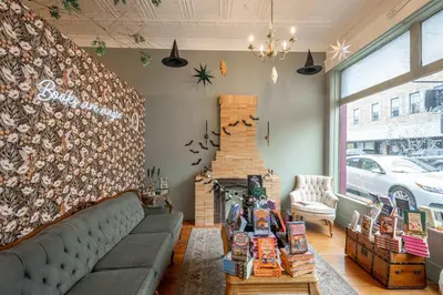 a store with a couch and a fireplace in a room at The Washington Cottage - 6ppl in Harrison