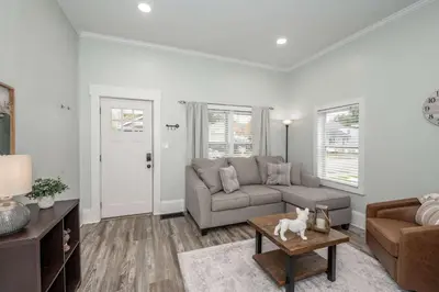 a living room with a couch and a dog on a coffee table at The Washington Cottage - 6ppl in Harrison
