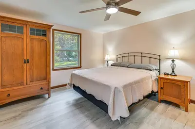 a bedroom with a bed and a ceiling fan at Dirt Road Digs - Quiet Home in Lakeville!