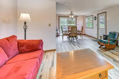 a living room with a couch and a table at Dirt Road Digs - Quiet Home in Lakeville!