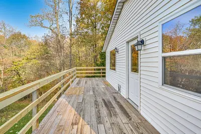 a wooden deck on the side of a house at Dirt Road Digs - Quiet Home in Lakeville!