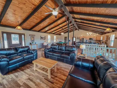 a living room with leather couches and a table at The Lodge at Hocking Hills - 2 Hot Tubs - 6 acres - Lake access in Rockbridge