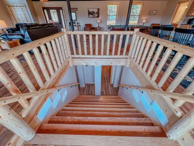 an overhead view of a wooden staircase in a house at The Lodge at Hocking Hills - 2 Hot Tubs - 6 acres - Lake access in Rockbridge
