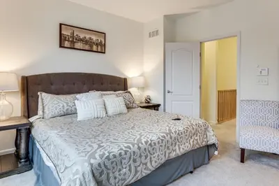 a bedroom with a large bed in a room at 1 Mi to Dtwn Cincinnati Spacious Townhome with Deck in Cincinnati