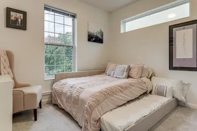 a bedroom with a bed and a couch and a window at 1 Mi to Dtwn Cincinnati Spacious Townhome with Deck in Cincinnati