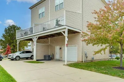 a house with a balcony with a car parked in front at 1 Mi to Dtwn Cincinnati Spacious Townhome with Deck in Cincinnati