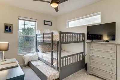 a bedroom with two bunk beds and a dresser at 1 Mi to Dtwn Cincinnati Spacious Townhome with Deck in Cincinnati
