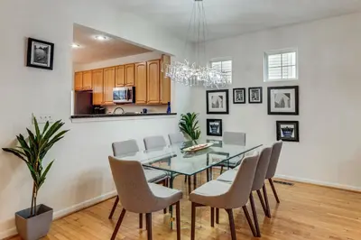 a dining room with a glass table and chairs at 1 Mi to Dtwn Cincinnati Spacious Townhome with Deck in Cincinnati