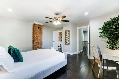 a bedroom with a bed and a ceiling fan at Spacious 4BR Home Near UD Oregon and DT Dayton in Dayton