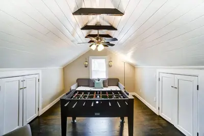 a room with a bed and a ceiling fan at Spacious 4BR Home Near UD Oregon and DT Dayton in Dayton