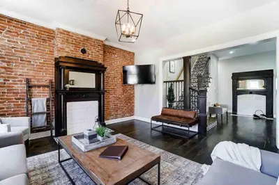 a living room with a brick wall at Spacious 4BR Home Near UD Oregon and DT Dayton in Dayton