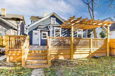 a wooden deck with a pergola in front of a house at Spacious 4BR Home Near UD Oregon and DT Dayton in Dayton