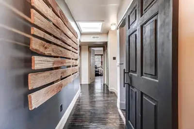 a hallway with a wooden accent wall and a door at Dayton Loft close to DT Oregon UD in Dayton