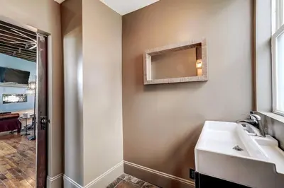 a bathroom with a sink and a mirror on the wall at Dayton Loft close to DT Oregon UD in Dayton