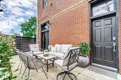 a patio with two chairs and a table and a building at Dayton Loft close to DT Oregon UD in Dayton