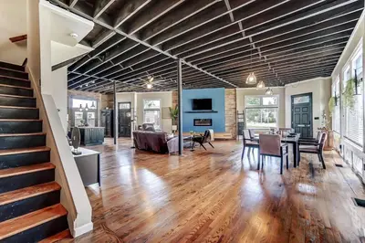 a living room with a table and chairs and a staircase at Dayton Loft close to DT Oregon UD in Dayton