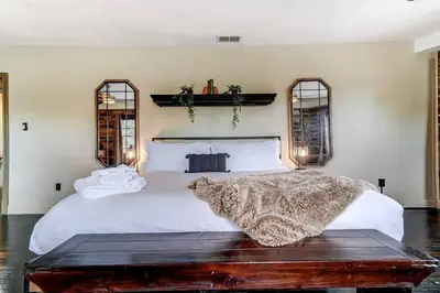 a bedroom with a white bed with a blanket on it at Dayton Loft close to DT Oregon UD in Dayton