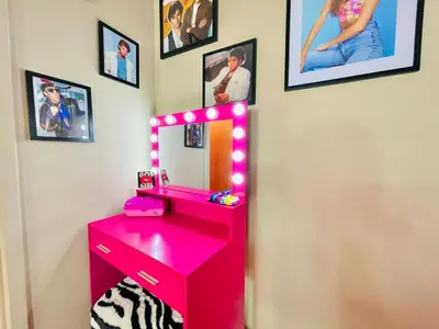 a red vanity with a mirror and a pink dressing table at Radical 80's Getaway! A Blast From The Past! in Sandusky