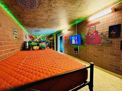 a bedroom with an orange bed in a brick wall at Radical 80's Getaway! A Blast From The Past! in Sandusky