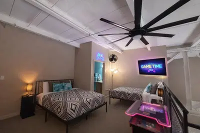 a bedroom with two beds and a ceiling fan at Downtown Sleeps 8 By Cedar Point & Sports Force! in Sandusky