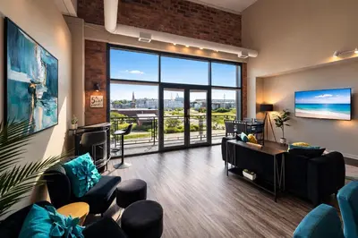 a living room with a view of the ocean at Downtown Sleeps 8 By Cedar Point & Sports Force! in Sandusky