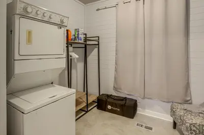 a small kitchen with a refrigerator and a shower at 2 Mi to Dtwn Charming Sandusky Getaway with Hot Tub in Sandusky