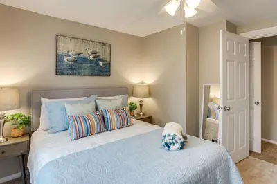 a bedroom with a bed with a blue comforter at 2 Mi to Dtwn Charming Sandusky Getaway with Hot Tub in Sandusky