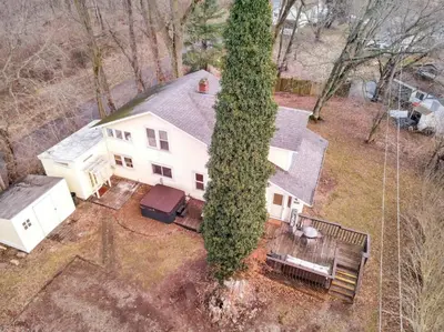 an overhead view of a white house with a large tree at Canary Cottage in Thornville