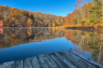a view of a lake in the fall at Lake Access and Hot Tub! Serene Rockbridge Cabin in Rockbridge