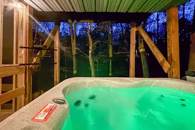 a bath tub in a room with a window at Lake Access and Hot Tub! Serene Rockbridge Cabin in Rockbridge