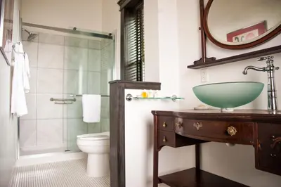 a bathroom with a green sink and a toilet at The Hackett Hotel in Marietta
