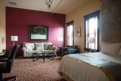 a hotel room with a bed and a living room at The Hackett Hotel in Marietta