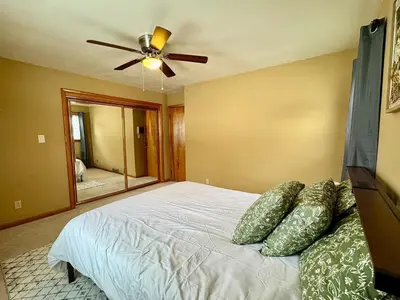 a bedroom with a bed with a ceiling fan at Cozy house for small or big group in Bridgeport WV in Bridgeport