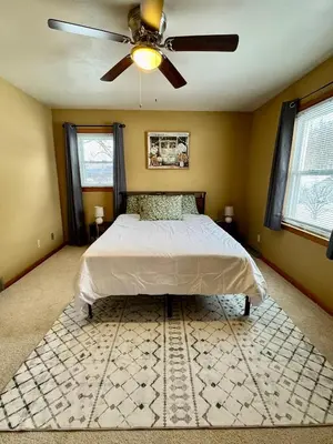 a bedroom with a bed and a ceiling fan at Cozy house for small or big group in Bridgeport WV in Bridgeport