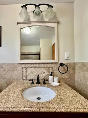 a bathroom with a sink and a mirror at Cozy house for small or big group in Bridgeport WV in Bridgeport