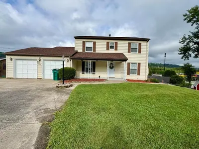 a large house with a grass yard in front of it at Cozy house for small or big group in Bridgeport WV in Bridgeport