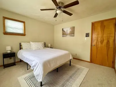 a bedroom with a bed with a ceiling fan at Cozy house for small or big group in Bridgeport WV in Bridgeport