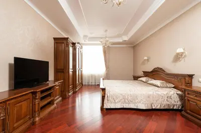 a bedroom with a bed and a flat screen tv at Cincinnati Hotel in Cincinnati