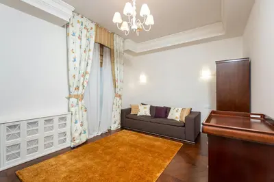 a living room with a couch and a piano at Cincinnati Hotel in Cincinnati