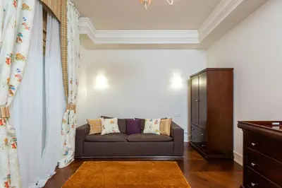 a living room with a couch and a cabinet at Cincinnati Hotel in Cincinnati