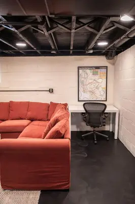 a living room with a red couch and a desk at The Railway Retreat - Downtown Sylvania in Sylvania