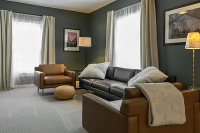 a living room with a couch and a chair at The Railway Retreat - Downtown Sylvania in Sylvania