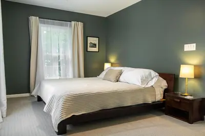 a bedroom with a large bed and a window at The Railway Retreat - Downtown Sylvania in Sylvania